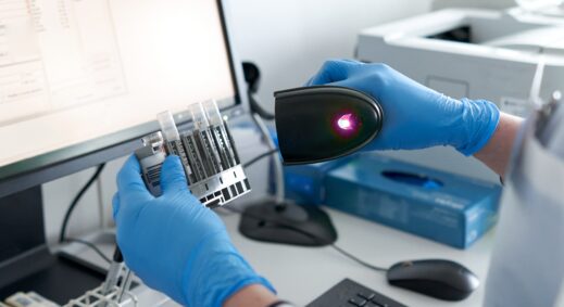 New York Blood Center Enterprises technician scanning bar code on research product.