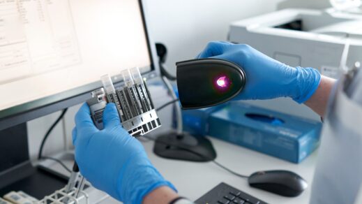 New York Blood Center Enterprises technician scanning bar code on research product.